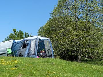 Van with awning on the upper field pitch