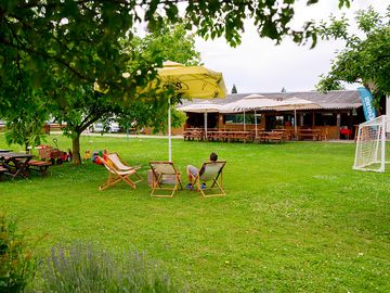 Large grassy area with deckchairs and football goal