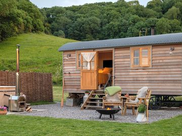 Shetland view a cosy shepherd hut with a king-size bed,wood-fired hot tub, bbq/fire pit,and stunning