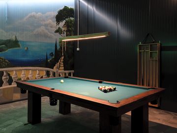 Billiard room at camping palić with professional table and cosy lighting.