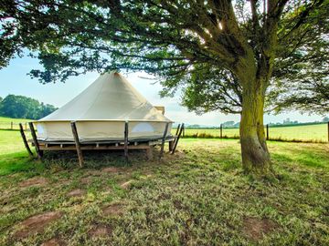 Bell tent in its own corner of the field