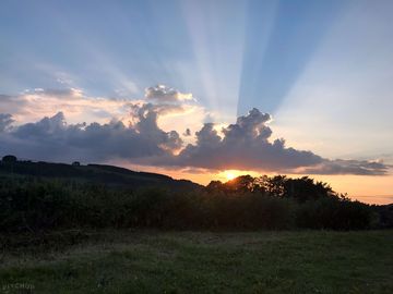 Watch the sun set over the nith valley from the field