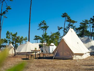 Each tent has a picnic table outside