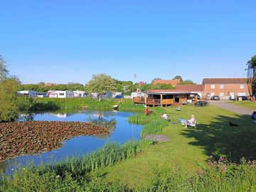 A view of the fishing pond, Waterside pitches and the bar.