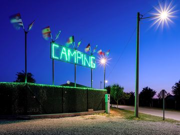 Illuminated entrance sign “CAMPING” at Camping Palić - easy to find at night, welcoming travelers.