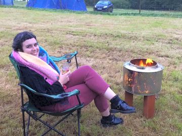 A great picture that was taken by a camper of their family enjoying the site and their firepit!