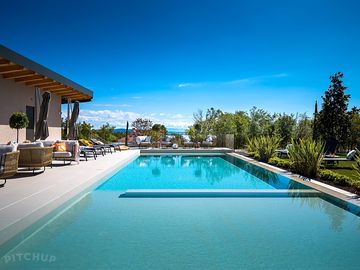 Sunloungers all around the pool