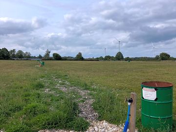 Drinking water stand taps line up along middle of field for easy access