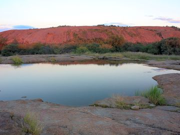 Natural lake by a granite outcrop