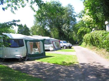 Hardstanding area with grass, ideal for awnings