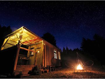 Cabin with a star-filled night sky