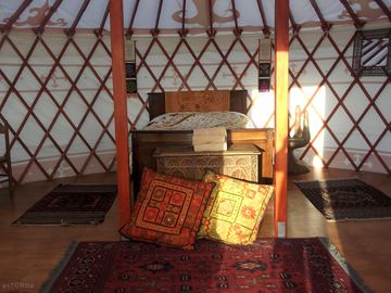 Double wooden sleigh bed for a luxurious nights sleep glamping.