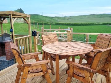 Outdoor seating area on the decking and new barbecue station, to use with a disposable barbecue