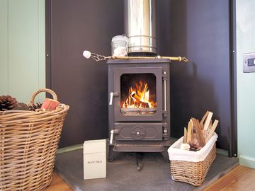 Woodburning stove with a supply of wood