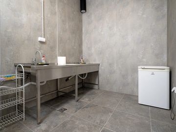 Dishwashing room with stainless-steel sinks and a practical utility area clean camp kitchen.