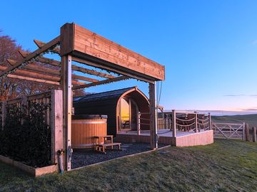 Sunset at stouslie snugs with new pergolas