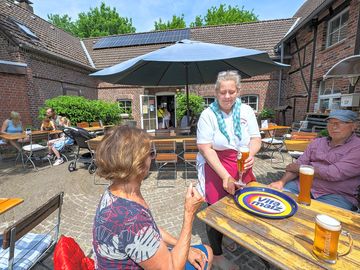 Landgasthaus klaukenhof beer garden in the sunshine. dining and drinking outside is also possible.