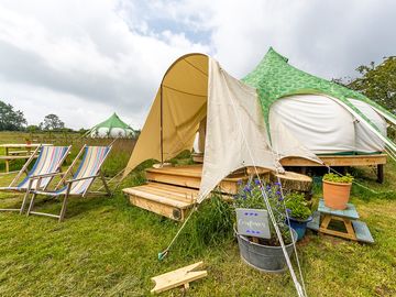 Exterior shot of tent, showing porch for storage, shade or a rainy g&t looking out across the views.
