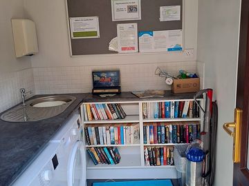 Laundry room with books to borrow