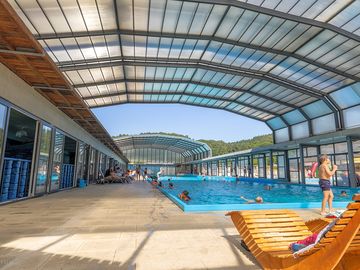 Swimming pool with retractable roof for swims in all weathers