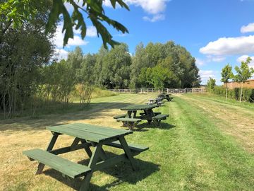 Grass pitch area with picnic tables