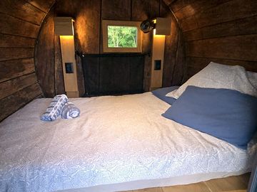 Barrel interior with bedding and towels provided