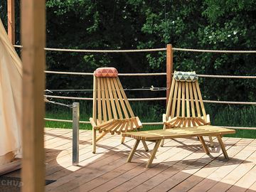 Your bell tent deck is furnished with handmade clam chairs to relax in.