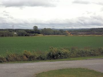 Open view to the rear of the site, across open fields and towards the cotswolds