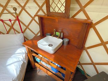 Yurt interior with wash stand