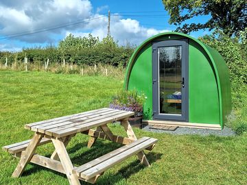 Green pod with picnic bench