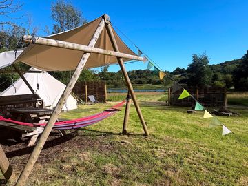 Hammock and picnic table outside the bell tent