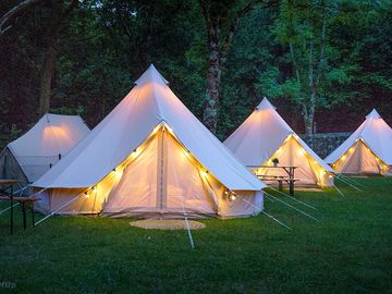 Bell tents lit up at night