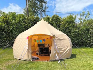 Bell tent sheltered by trees
