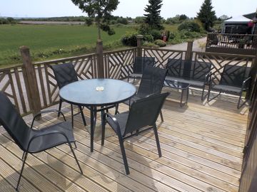 Decking area with garden furniture and barbecue, ideal for alfresco dining
