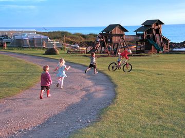 Play park with touring pitches in the background