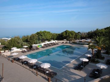 Swimming pool with sun loungers and umbrellas