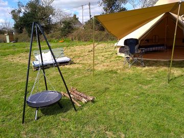 Fire pit and tripod outside the bell tent