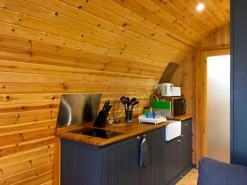 Kitchenette with an induction hob, fridge-freezer, kettle, toaster and microwave