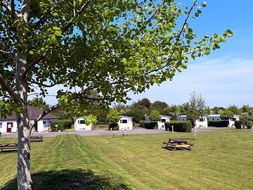 Electric grass pitches in front of static caravans