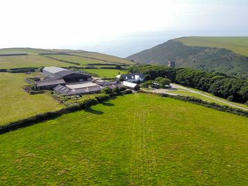 View of the camping field, farm and the church spire
