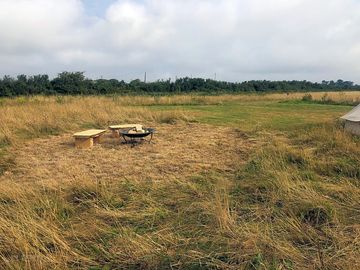 Meadow with firepit for additional tent pitch