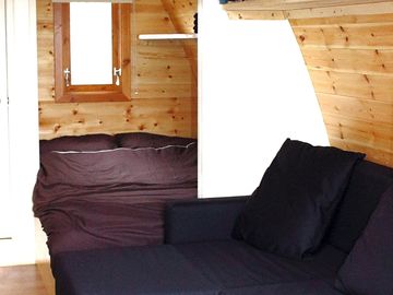 Inside the pod with a double bed and a sofa bed
