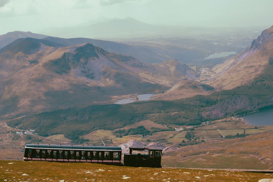 See Snowdonia’s mountains by train (Akinyemi/Unsplash)