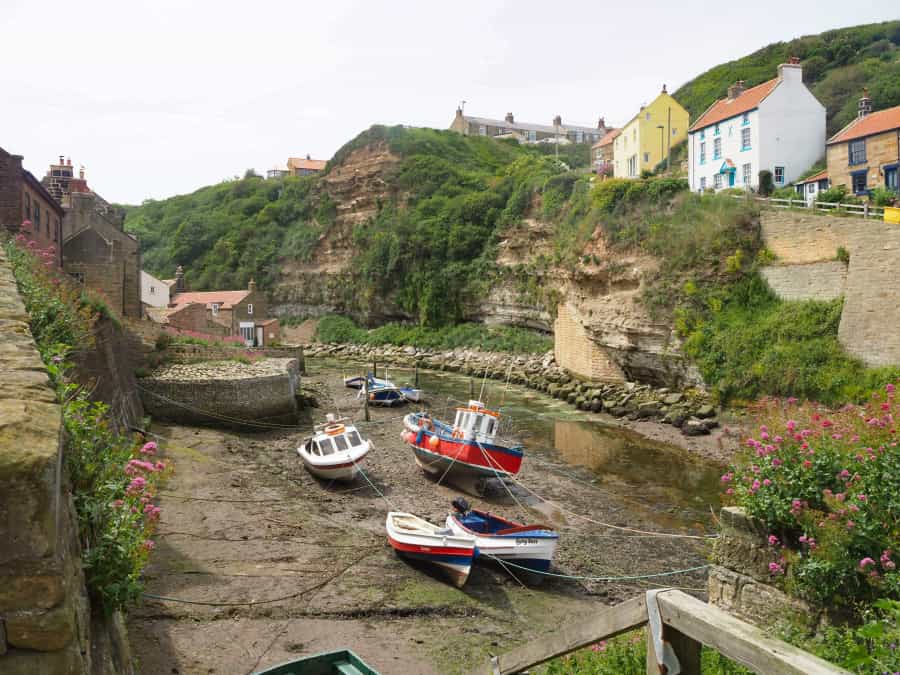 Cycle along the coast to the atmospheric fishing village at Robin Hood’s Bay (Don Lodge/Unsplash)